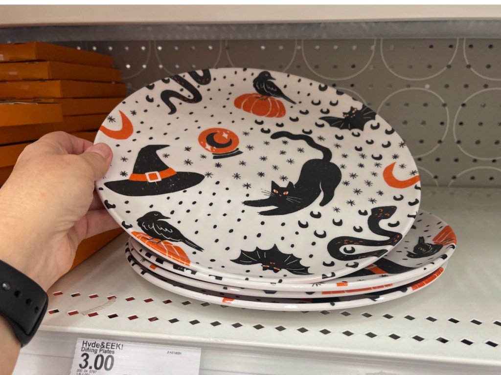 hand holding Hyde & EEK! Boutique Halloween Icons Dinner Plate at the store