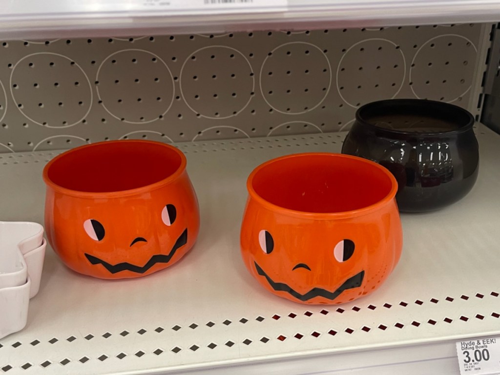 hand holding Hyde & EEK! Boutique Halloween Pumpkin Figural Snack Bowl at the store
