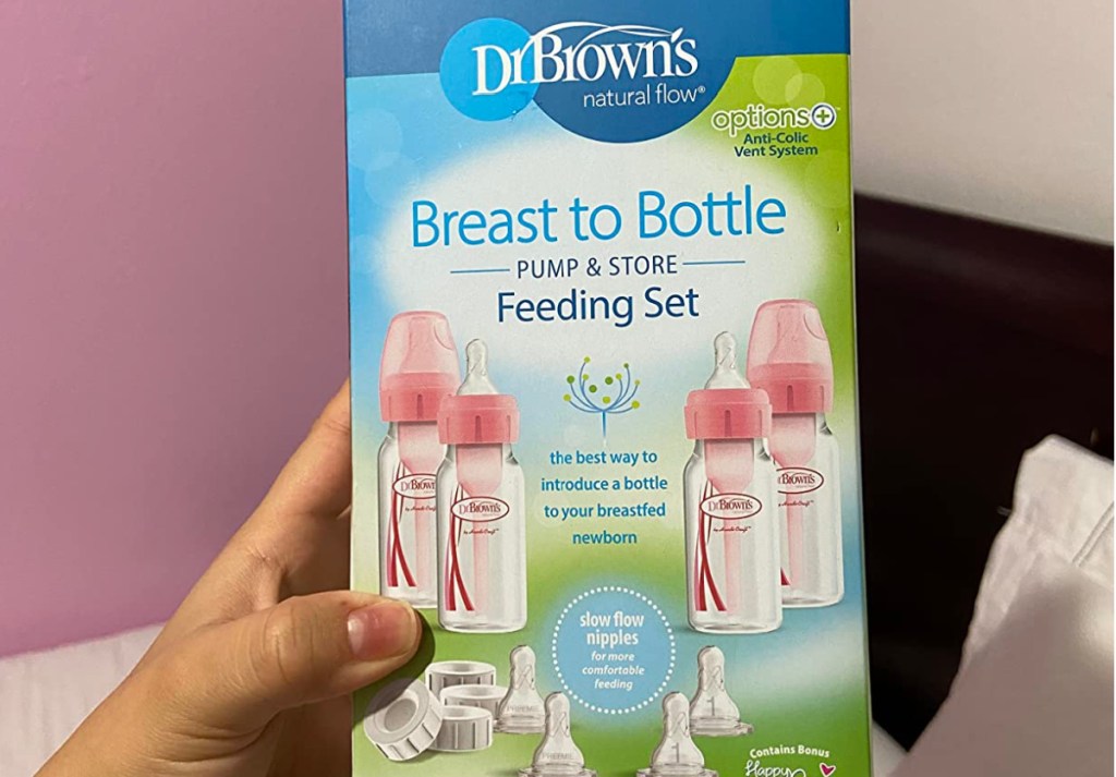 hand holding dr brown bottle feeding set