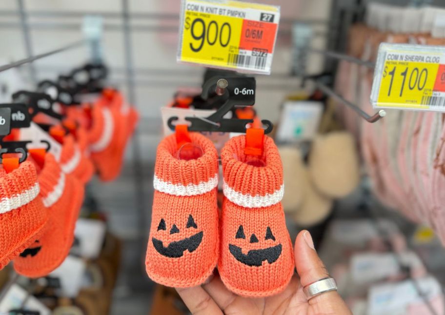 a pair of jack o lantern baby booties