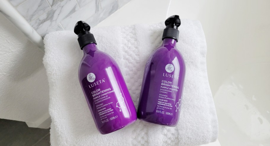 two bottles of purple luseta shampoo and conditioner