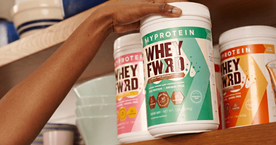 hand reaching for myproetin whey fwrd jars on shelf