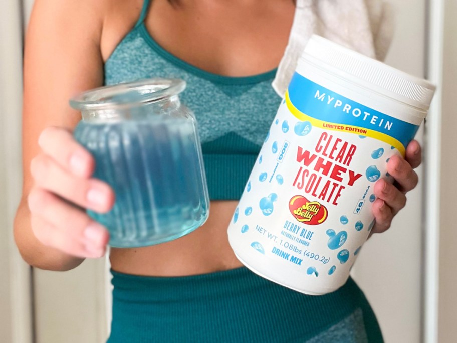 hand holding jelly belly jar and cup 