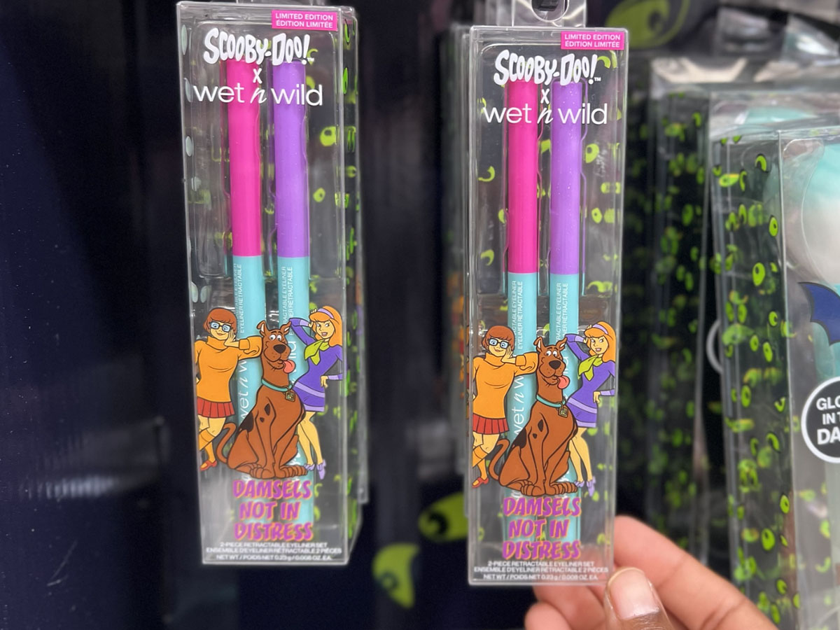 hand holding Wet N Wild Scooby Doo eyeliner hanging on shelf