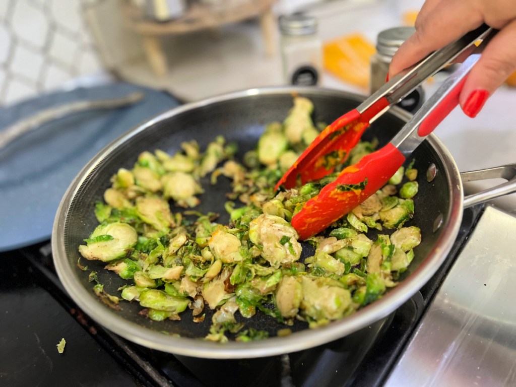 tossing shaved brussels sprouts