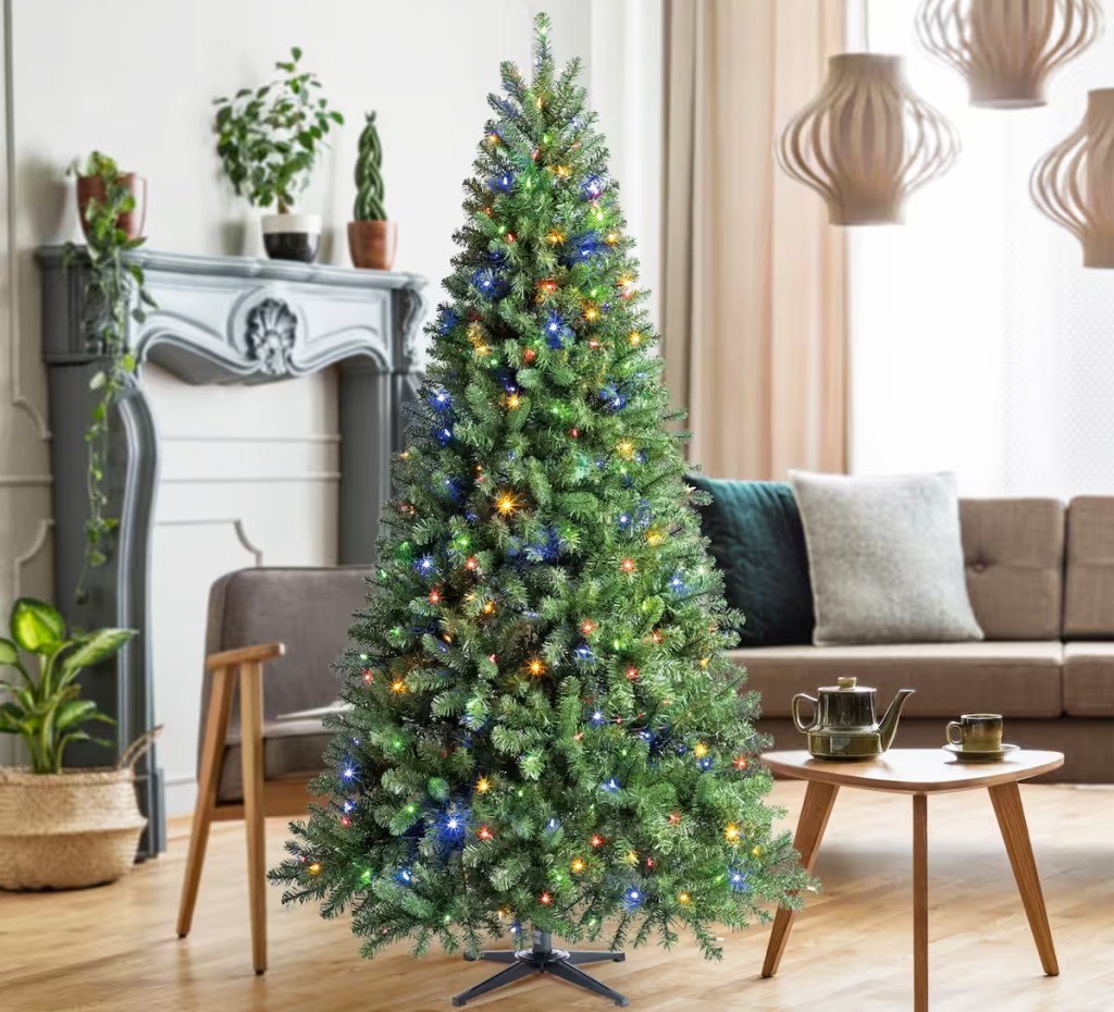 pre-lit christmas tree in living room with multi color lights