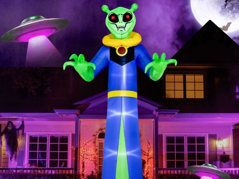 halloween alien inflatable displayed outside of a home