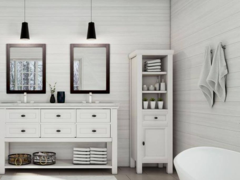 a white linen cabinet in the corner of a bathroom