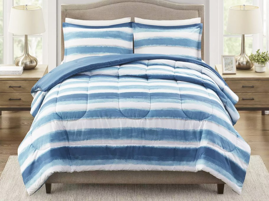 blue and white striped comforter set on bed