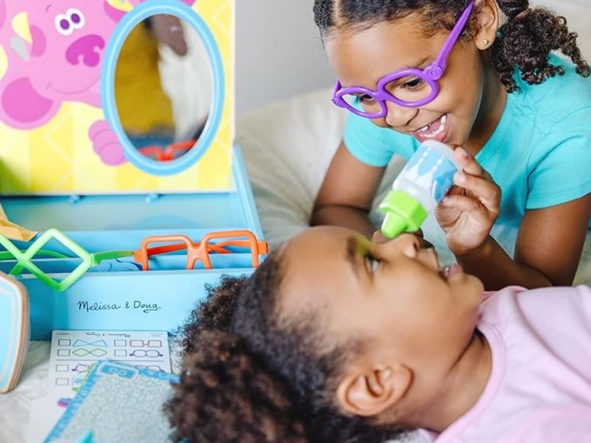 2 girls playing with blues clues eye doctor set