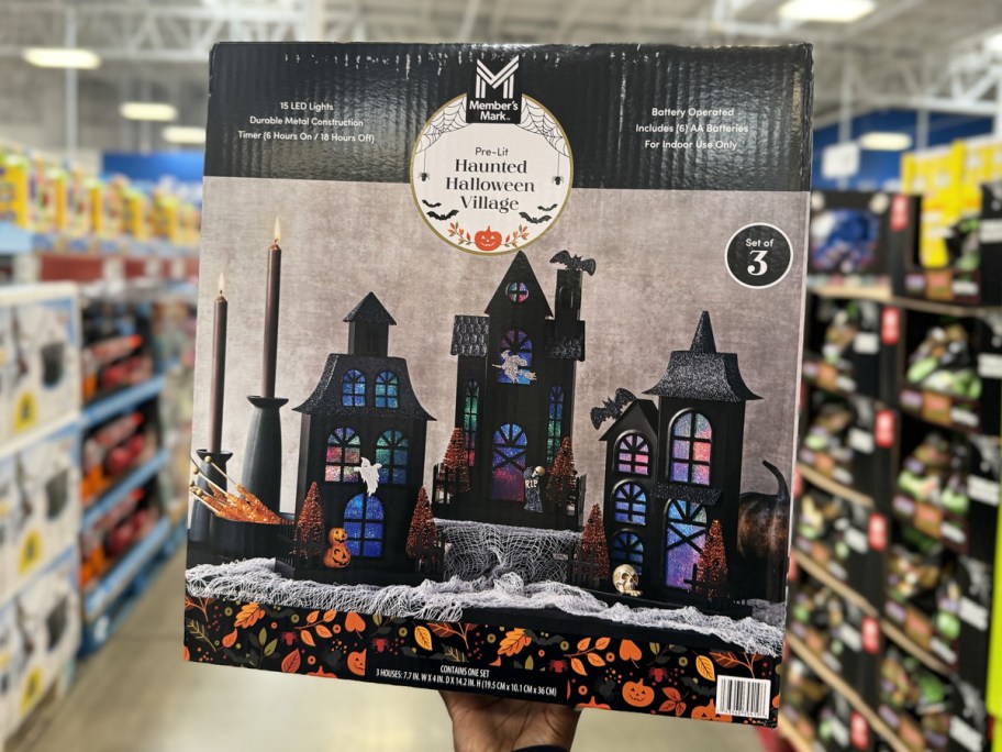 holding a box for halloween haunted houses in store