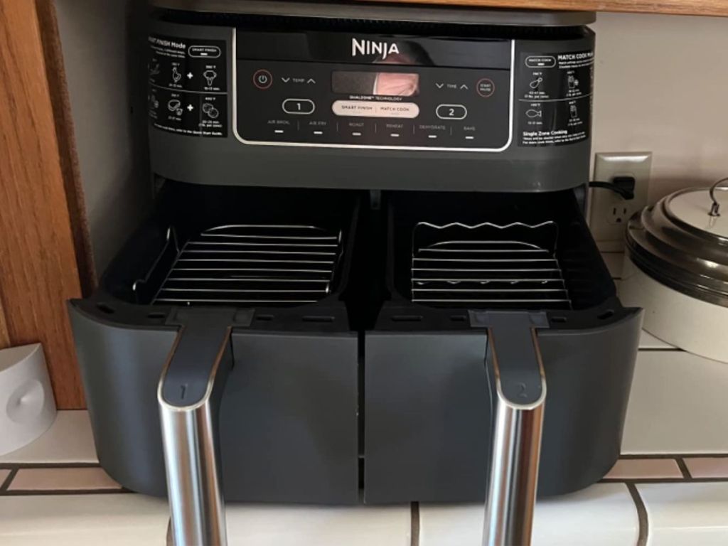 A ninja Foodi air fryer with the baskets slightly pulled out