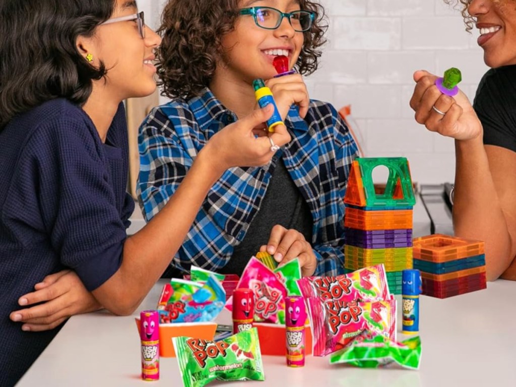 woman and girls enjoying ring pops in kitchen