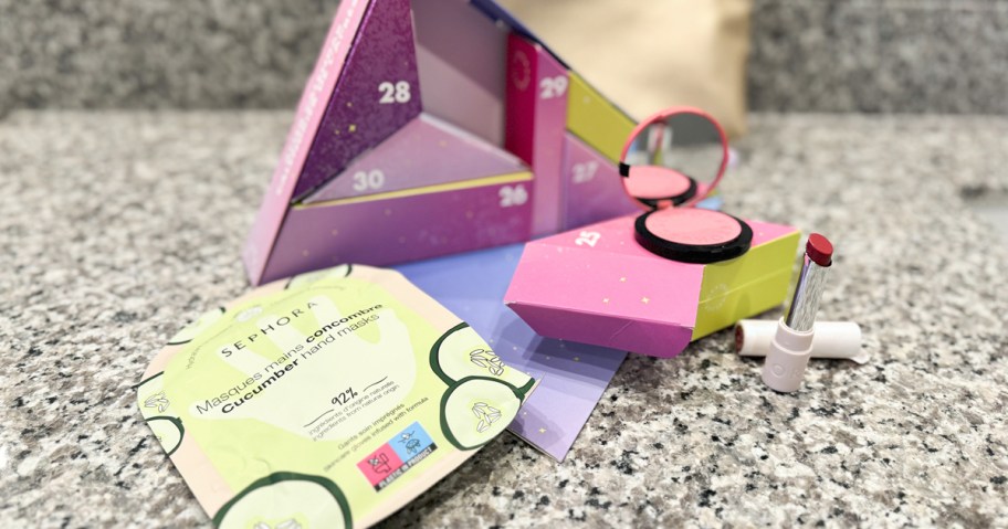 beauty products around a triangular advent calendar