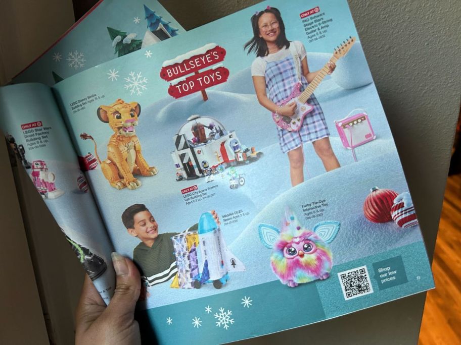 Someone holding a Target Toy Catalog 2024 Mailer