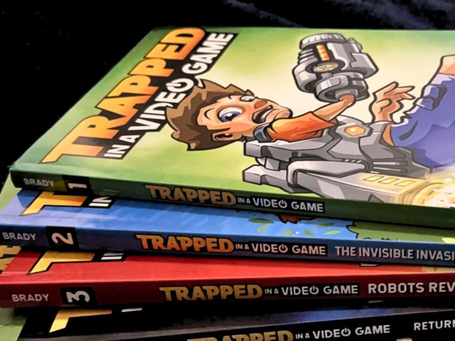 A stack of books from the Trapped n a Video Games Series