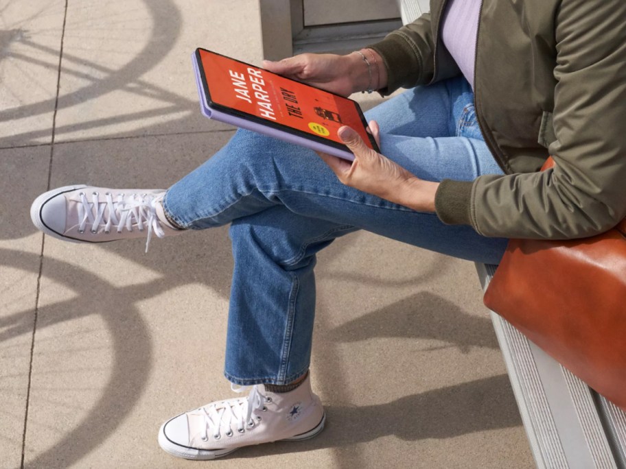 person sitting with amazon fire tablet in hands