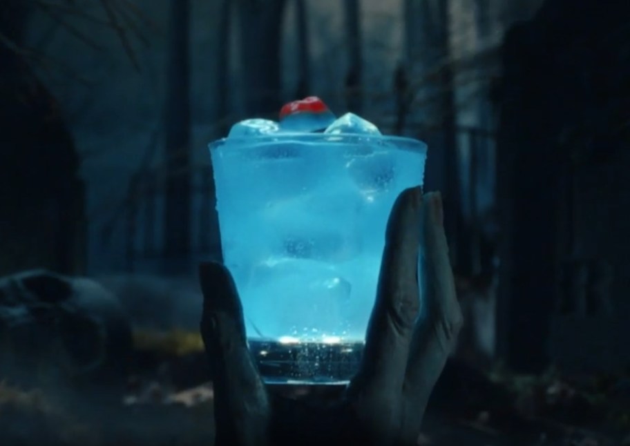 zombie hand holding a blue cocktail