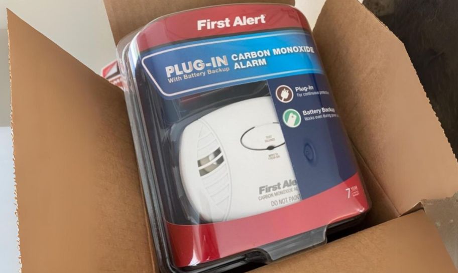 a first alert plug in carbon monoxide detector in an opened cardboard box.