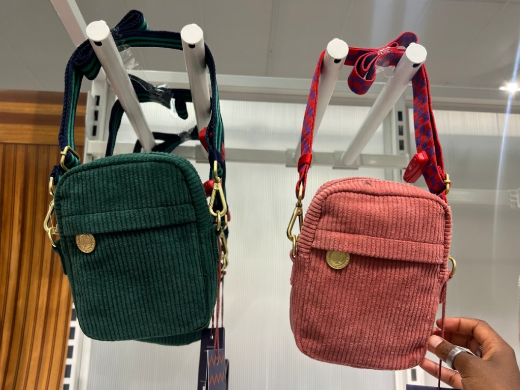hand showing corduroy greem o and pink crossbody