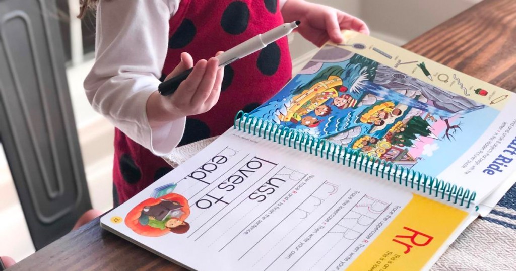 girl writing in highlights book