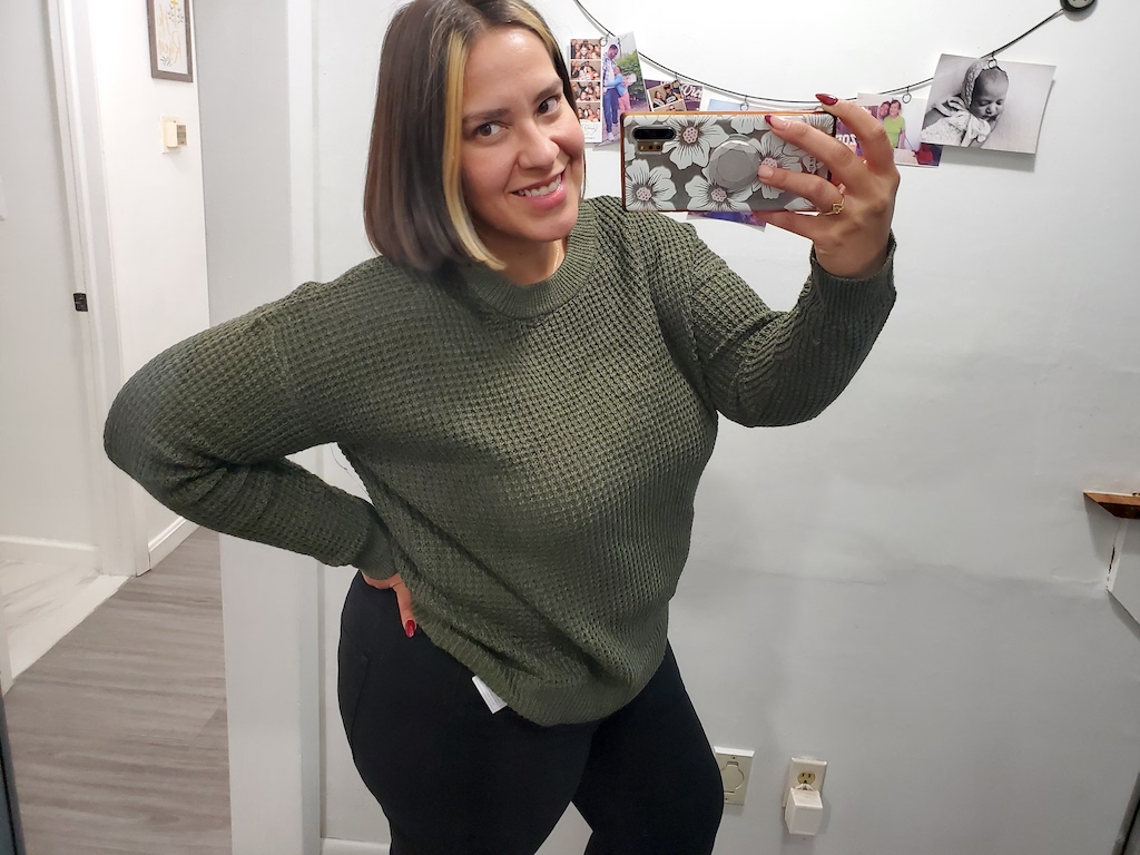 woman wearing waffle knife green sweater 