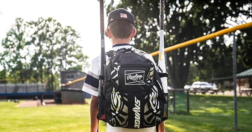 kid wearing rawlings backback with baseball bats 