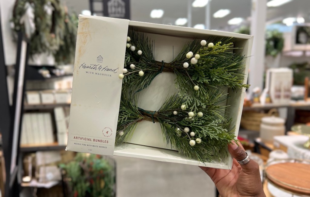 hand holding a box of Faux Pine & Snowberry Christmas Sprigs