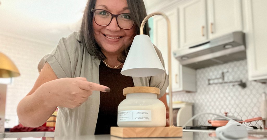 woman pointing to candle lamp