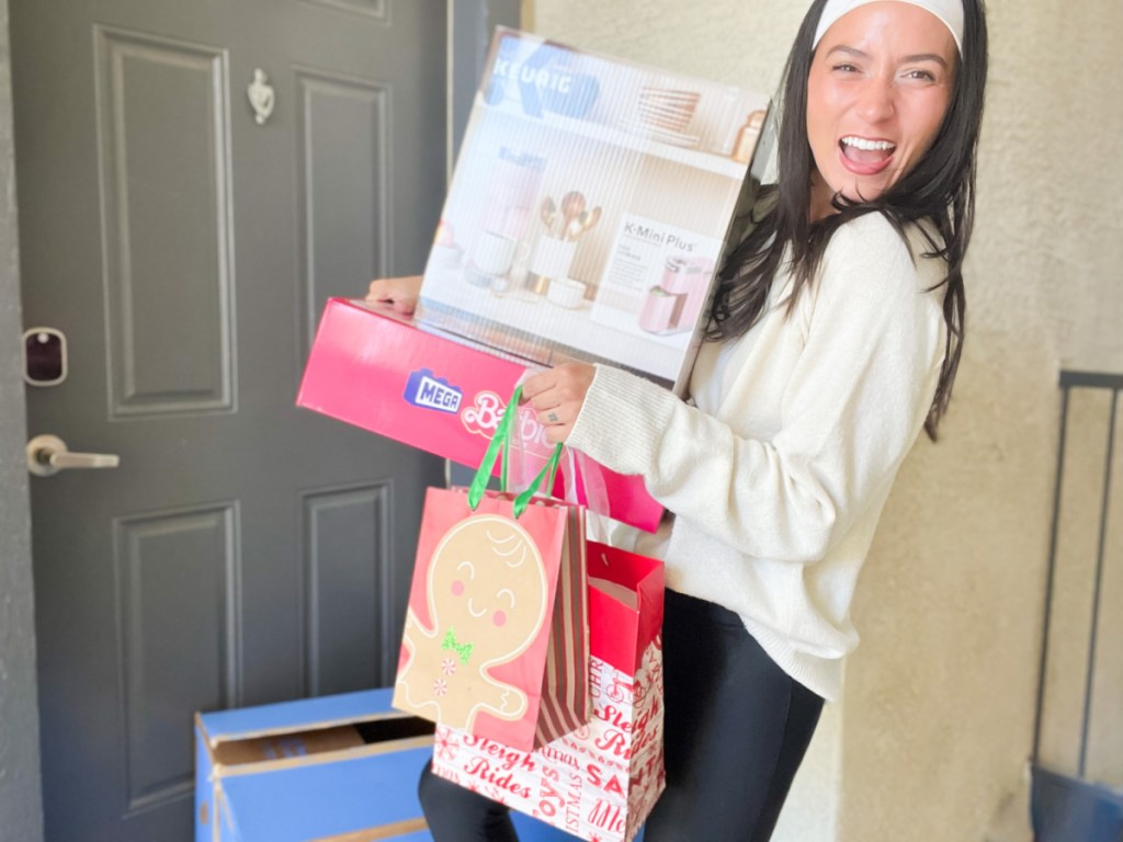 woman holding boxes at door