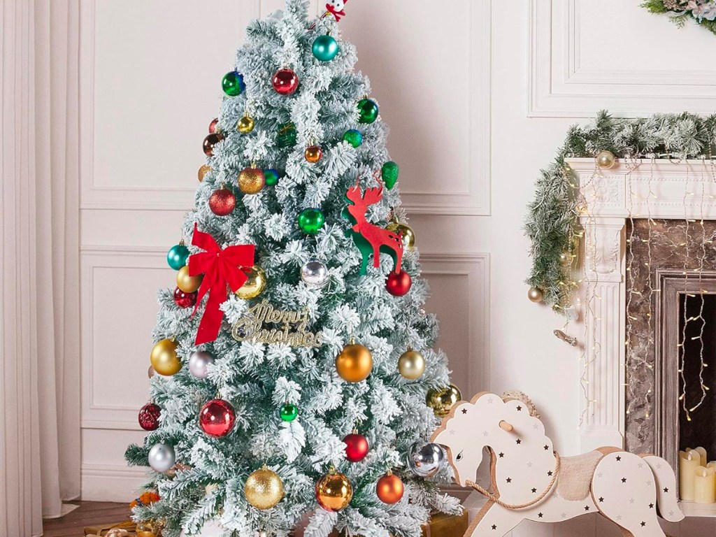 snow flocked christmas tree decorated in living room