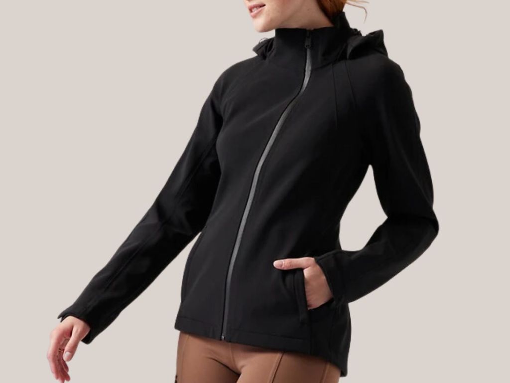 woman wearing a black Athleta zip up jacket