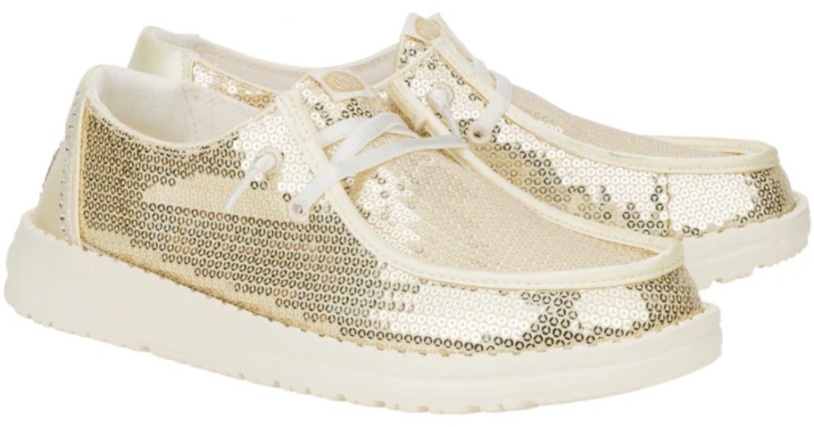 pair of champagne color sequin heydude women's disco shoes