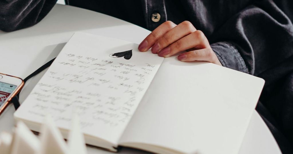 An open journal with writing inside