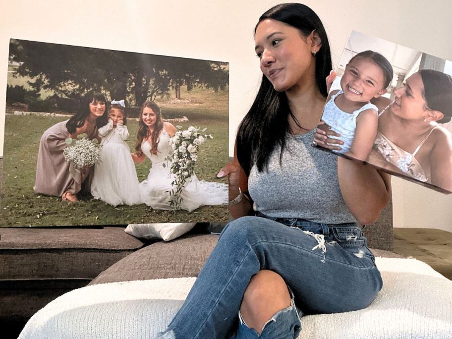 woman holding 2 canvas champ canvases