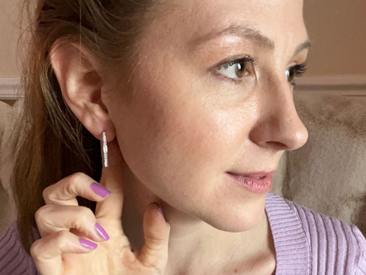 woman wearing silver hoop earrings