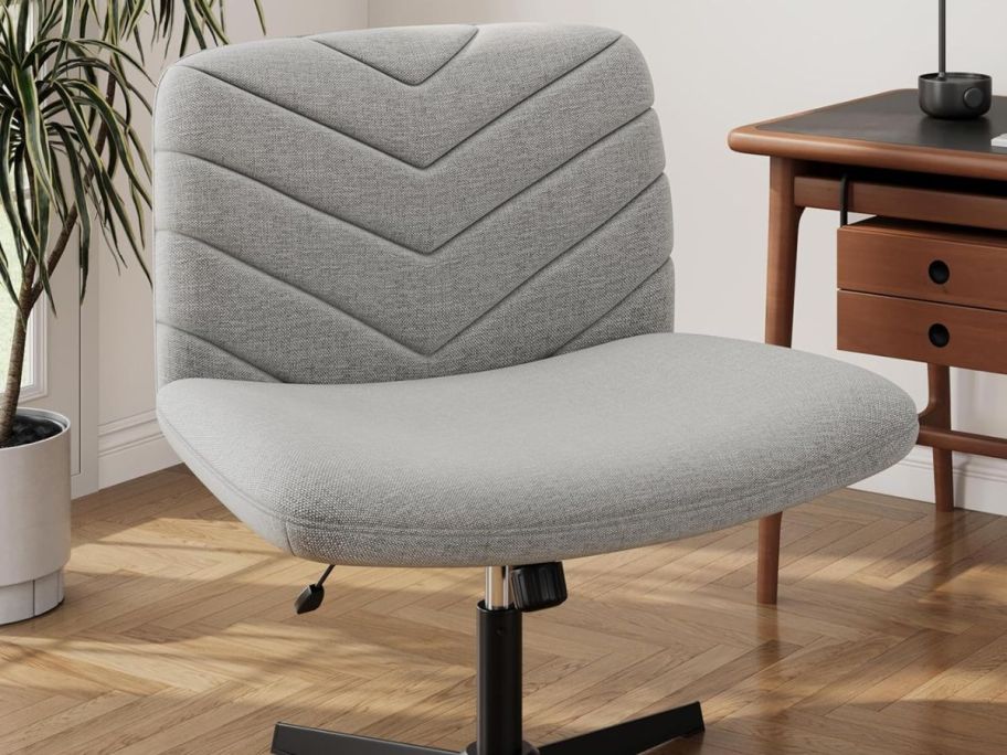 gray criss cross chair displayed in a room