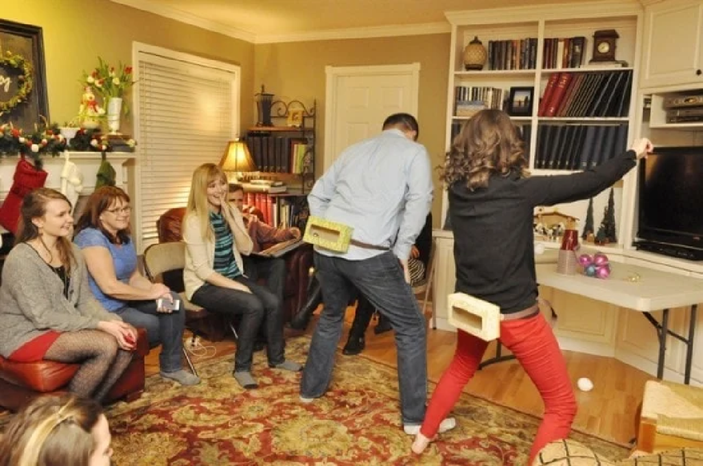 family playing a minute to win it christmas game called Jingle In the Trunk