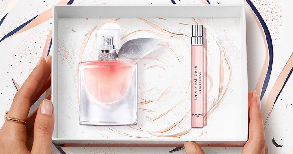 hands touching a boxed set of Lancome La Vie Est Belle perfumes