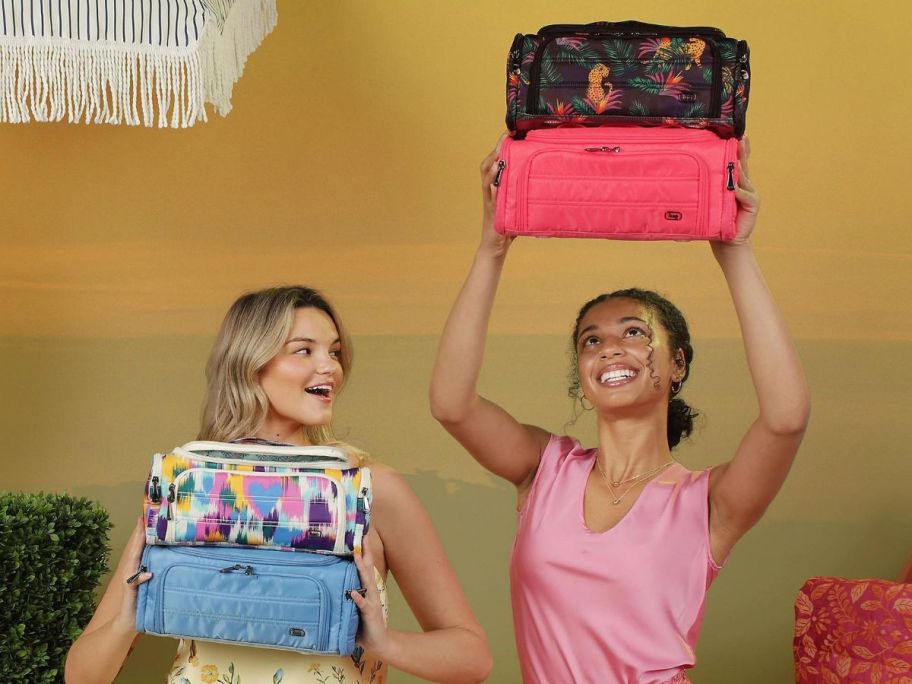 two women holding 2 Lug Cosmetic Case Trolleys