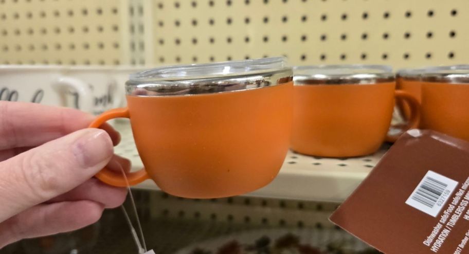 hand holding Orange stainless steel mini mug