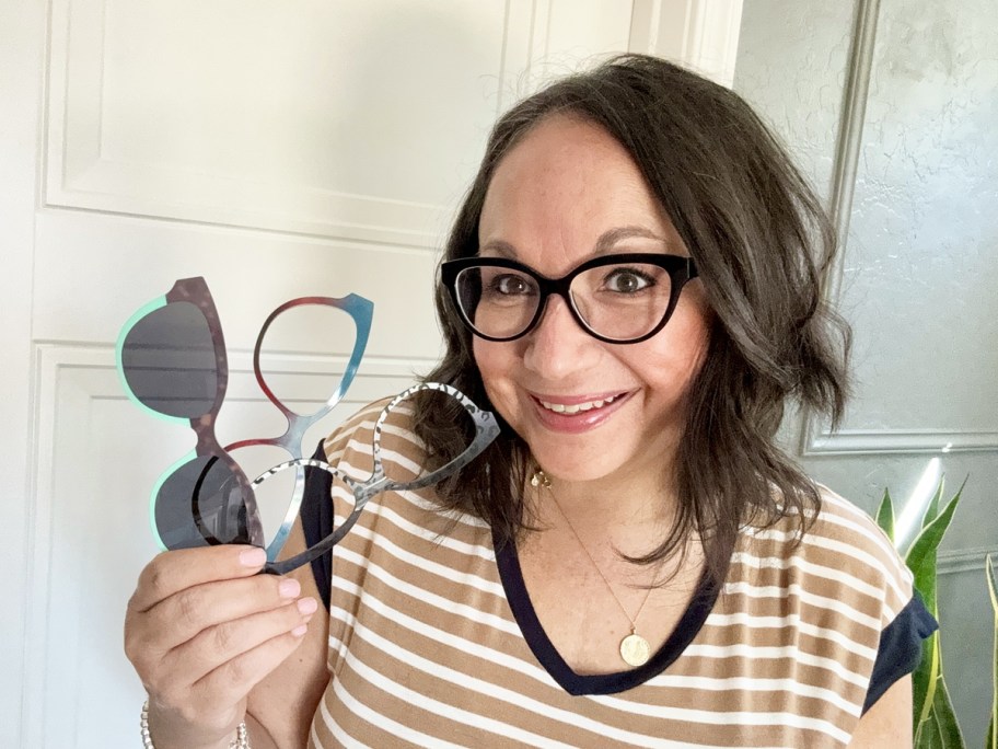 woman holding up 3 glasses toppers