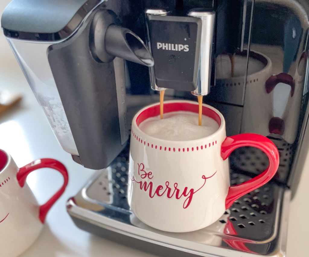 close up of the Philips 3200 Series Fully Automatic Espresso Machine LatteGo Milk Frother on a kitchen counter brewing a mug of coffee