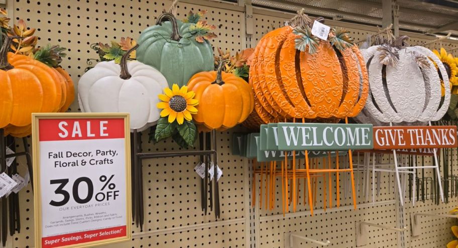 display of different pumpkin stakes with a 30% off signs