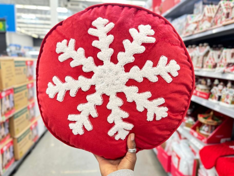 Red Snowflake Round Velvet Decorative Pillow in womans hand