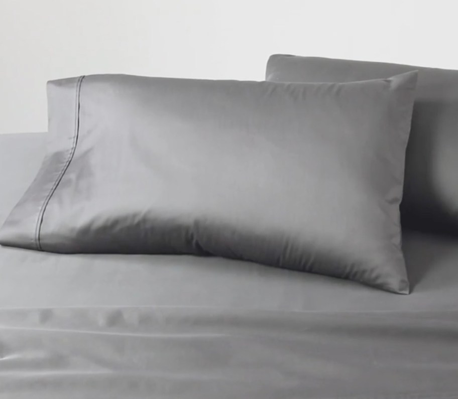 gray pillowcases and pillows on bed
