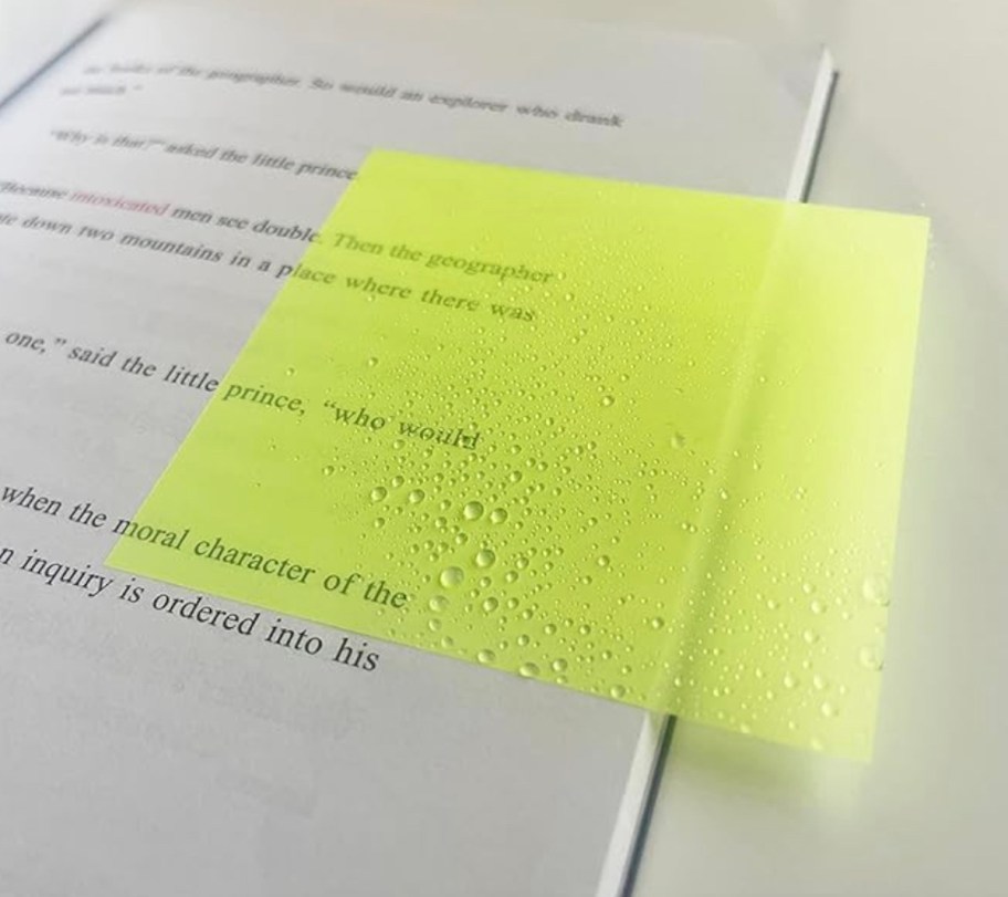 Yellow translucent sticky note in book 