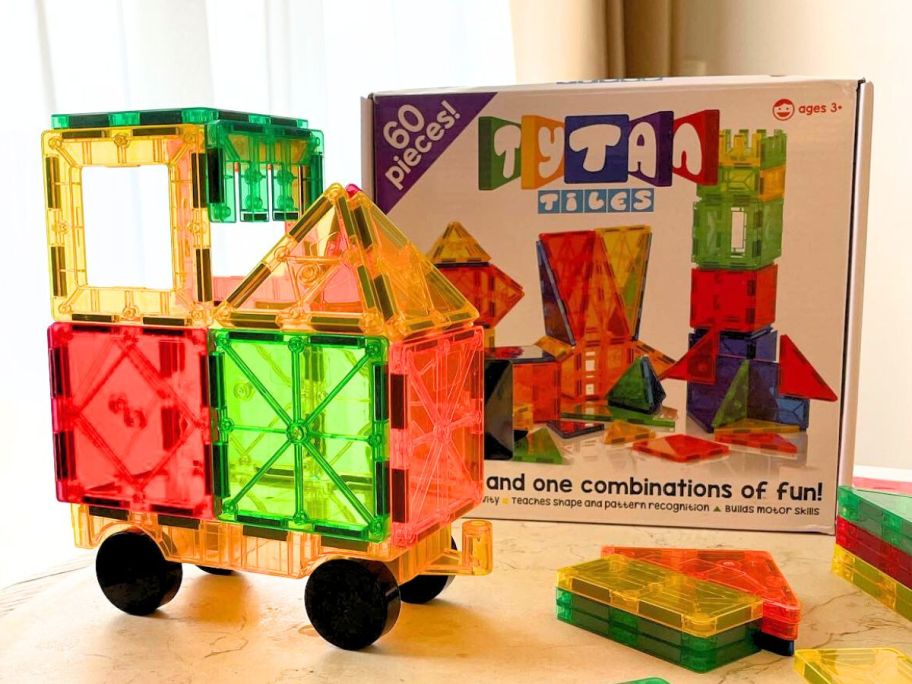 A 60-piece Set of Tytan tiles with a car displayed in front of the box