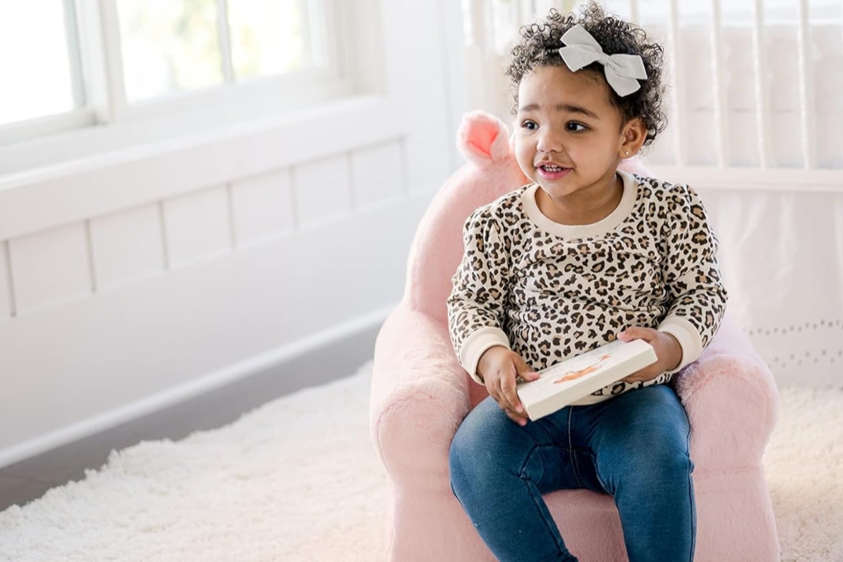 Toddler sitting in Unicorn chair.