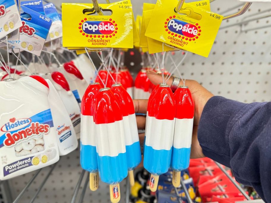 Popsicle Firecracker Ornaments hanging up at Walmart with a hand touching one